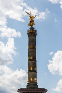 Low angle view of victory column against cloudy sky