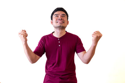 Young man looking away against white background