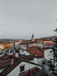 High angle view of buildings in town against sky