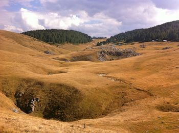 Scenic view of landscape and mountains against sky