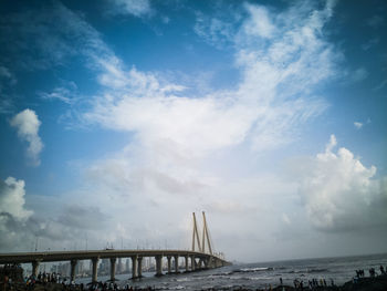 Low angle view of suspension bridge over river