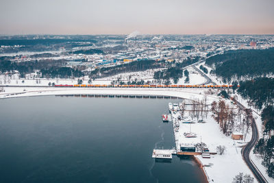 Aerial view of snow covered by sea against sky