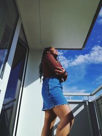 Low angle view of woman standing on balcony