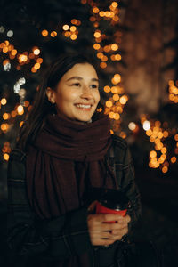 Happy woman at the christmas market at night