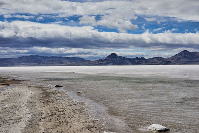 Scenic view of land and mountains against sky