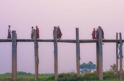 People on railing against sky