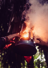 Cropped hand of man holding fire