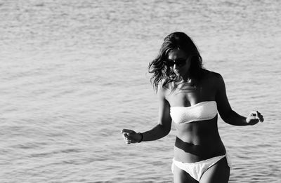 Woman wearing bikini while standing in sea