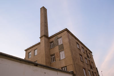 Low angle view of factory against sky