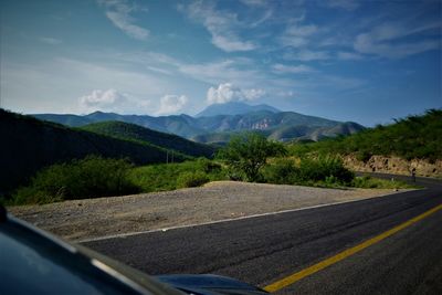 Mountains against sky seen through car windshield