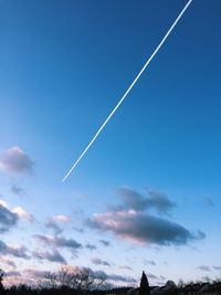 Low angle view of vapor trail in blue sky