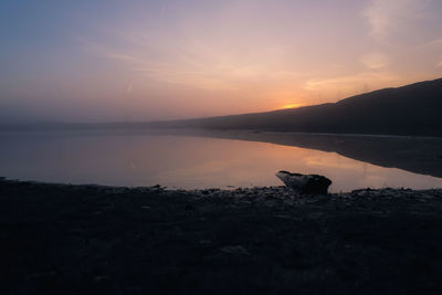 Scenic view of lake against sky during sunset
