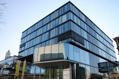 Low angle view of modern building against clear sky