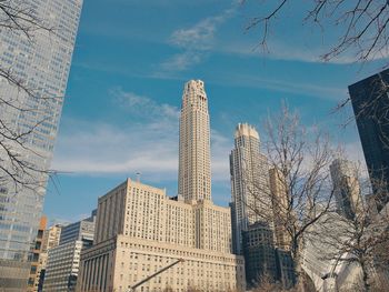 Skyscrapers against cloudy sky