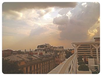 Buildings against cloudy sky