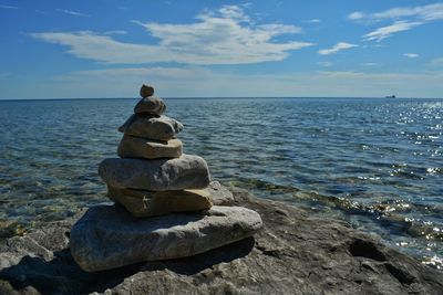 Rocks on beach against sky