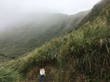 Rear view of woman walking on mountain