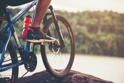 Low section of boy riding bicycle