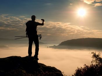 Dreamy fogy landscape. amateur photographer takes impressive photos with phone. hiker with backpack