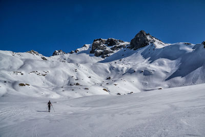 Scenic view of snowcapped mountain against clear blue sky