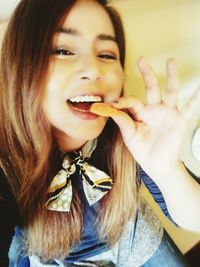 Close-up portrait of young woman eating food