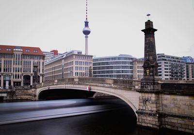 Bridge over river with buildings in background