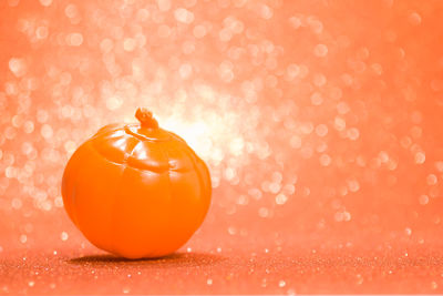 Close-up of orange fruit against red background