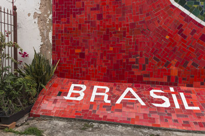 Text on red wall of building