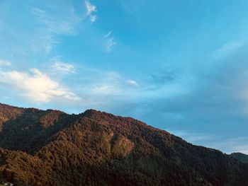 Low angle view of mountain against blue sky