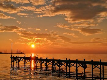 Scenic view of sea against orange sky