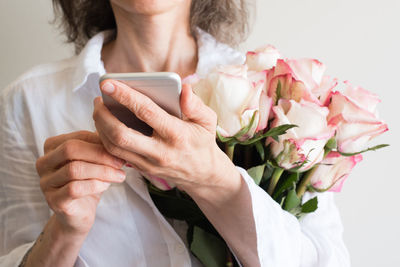 Midsection of woman using mobile phone