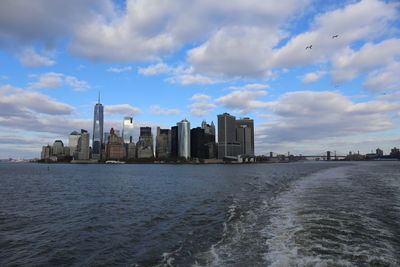 Scenic view of sea and buildings against sky