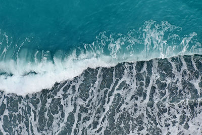 High angle view of waves rushing towards sea