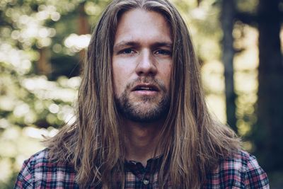 Close-up portrait of man with long hair