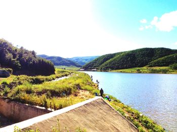 Scenic view of lake and mountains against sky