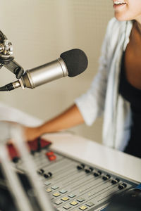 Microphone in podcasting studio - female announcer recording podcast