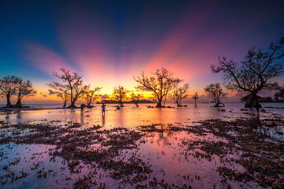 Scenic view of lake against orange sky