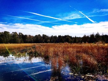 Scenic view of lake against cloudy sky