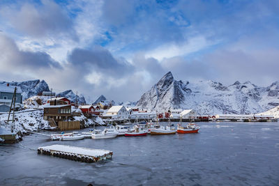 Nautical vessel on snowcapped mountains against sky