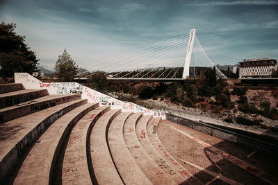 Bridge over road against sky in city