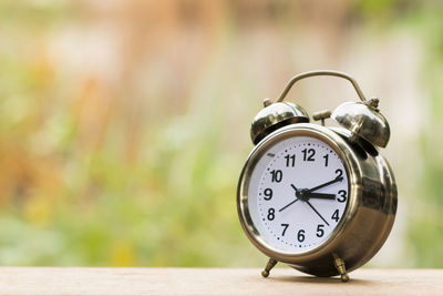 Close-up of clock on table