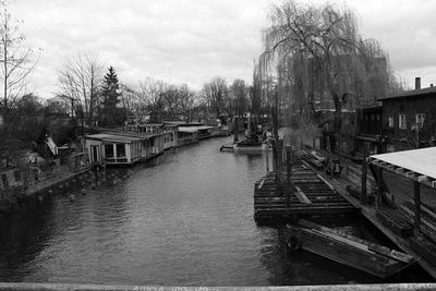 Footbridge over river with buildings in background
