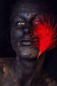 Close-up portrait of a man with red eyes