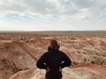 Rear view of woman standing on land