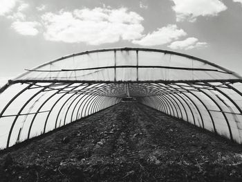 Soil in greenhouse against sky