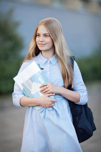 Portrait of beautiful teen blonde girl student . first day at school. model with  backpack