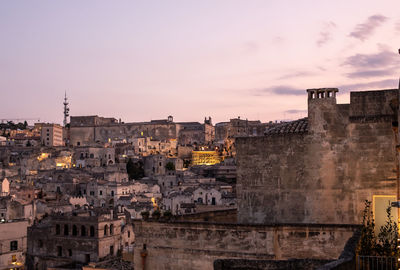 Buildings in city at sunset