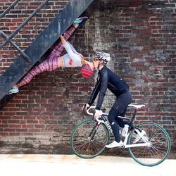 Bicycle parked against brick wall