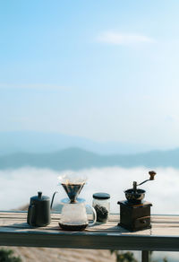 Coffee maker on table against sky