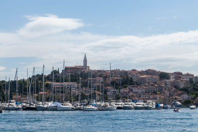 Boats sailing on sea against sky